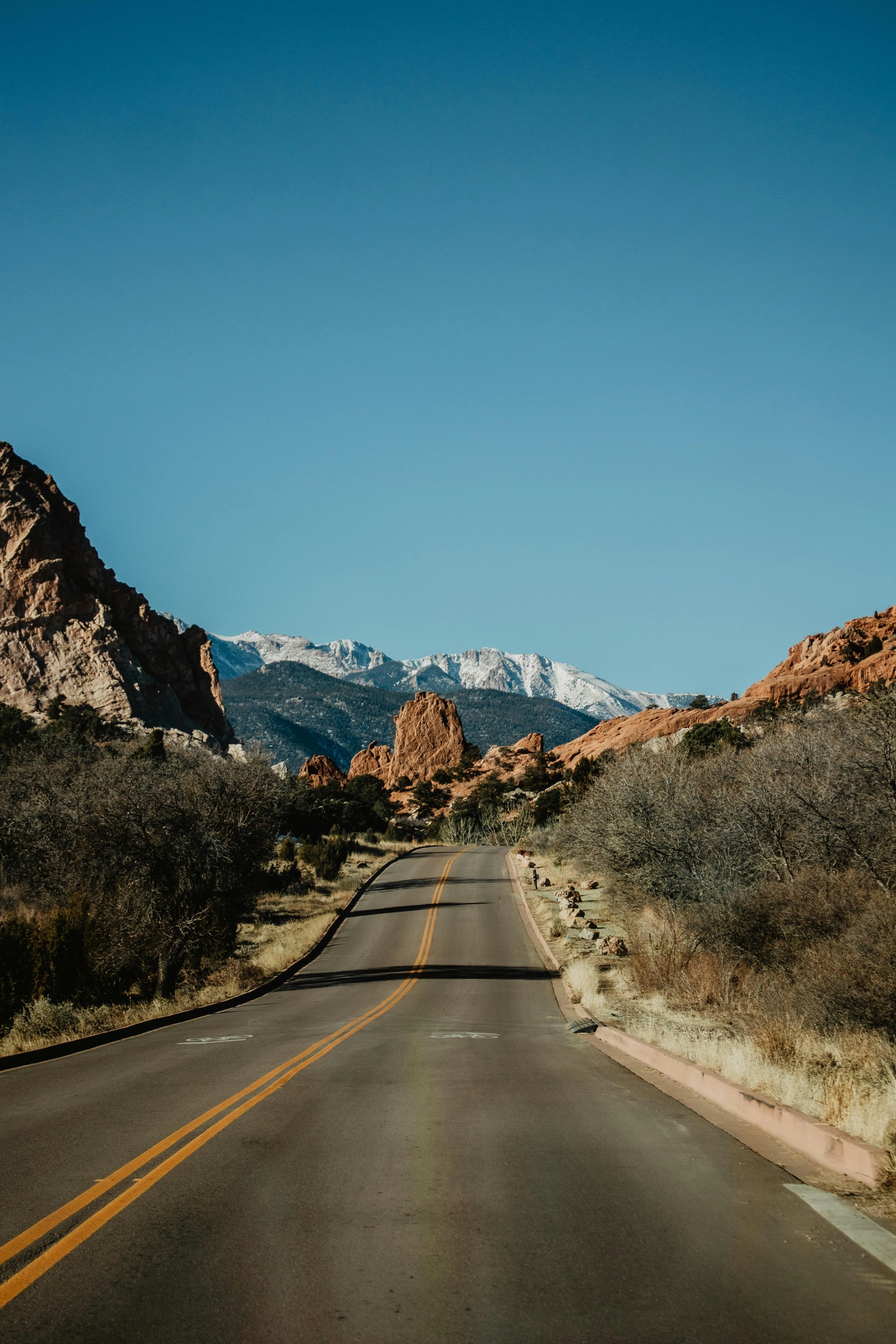 Road winding toward Pikes Peak and the red rock formations near Colorado Springs