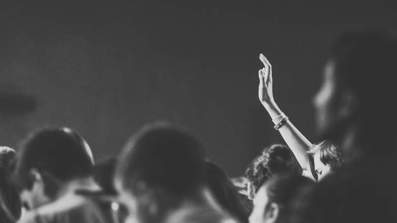 A resident raising a hand at a community meeting